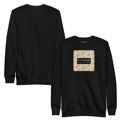 Black sweatshirt with square over chest that contains pattern of green geckos set on beige background, overlaid with black, rectangular logo with white lettering. Plain back also shown.