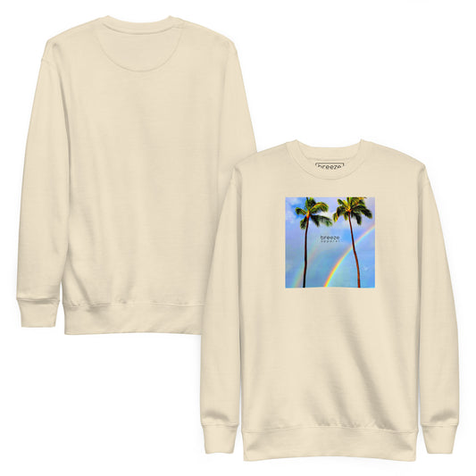 Beige sweatshirt with graphic of two palm trees with a rainbow in background. Plain back of shirt also shown.