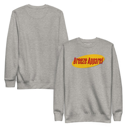 Gray sweatshirt with graphic of red lettering set on a yellow oval. Plain backside also shown.