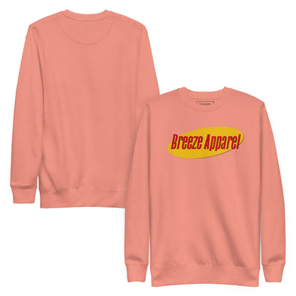 Pink sweatshirt with graphic of red lettering set on a yellow oval. Plain backside also shown.