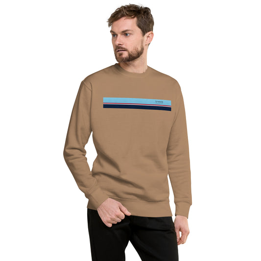 Man wearing brown sweatshirt with horizontal light-blue, red, white, and navy stripes across chest.