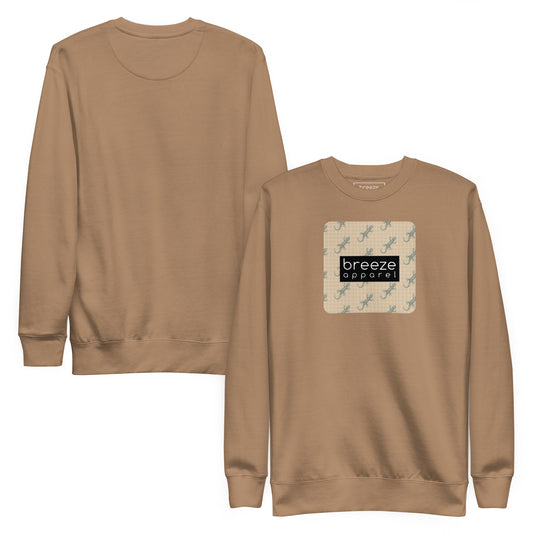 Brown sweatshirt with square over chest that contains pattern of green geckos set on beige background, overlaid with black, rectangular logo with white lettering. Plain back also shown.