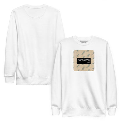 White sweatshirt with square over chest that contains pattern of green geckos set on beige background, overlaid with black, rectangular logo with white lettering. Plain back also shown.