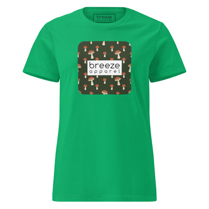 Green t-shirt with graphic of mushroom pattern set on a green background, overlaid with a white box with 'breeze apparel' in black inside.