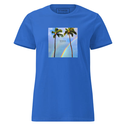 Royal-blue t-shirt with a graphic of palm trees, rainbow, and a clear blue sky in the background. A small, black 'breeze apparel' logo is between the trees. 