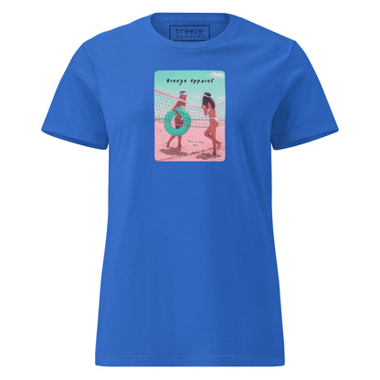 Royal-blue t-shirt with an image of two women in bikinis on the beach, standing by a volleyball net, one holding a swim ring and smiling, the other leaning on the net, with inscription in black of 'breeze apparel' towards the top of the image, and 'fun in the sun' in black on the ground between the women. 