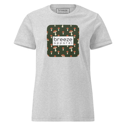 Gray t-shirt with graphic of mushroom pattern set on a green background, overlaid with a white box with 'breeze apparel' in black inside.