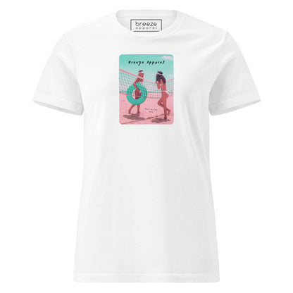 White t-shirt with an image of two women in bikinis on the beach, standing by a volleyball net, one holding a swim ring and smiling, the other leaning on the net, with inscription in black of 'breeze apparel' towards the top of the image, and 'fun in the sun' in black on the ground between the women. 
