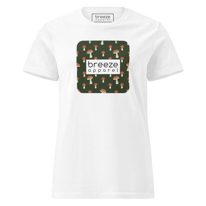 White t-shirt with graphic of mushroom pattern set on a green background, overlaid with a white box with 'breeze apparel' in black inside.