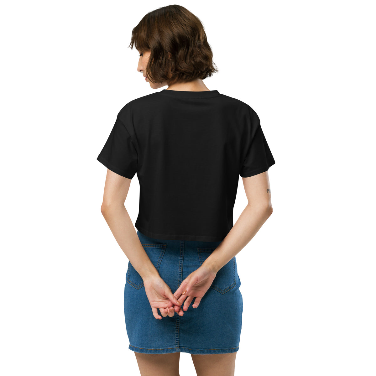 Rear view of woman wearing black crop top.