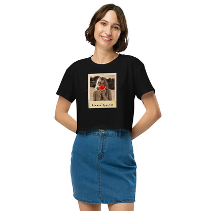 Woman wearing black crop top with graphic of woman holding piece of watermelon in front of her mouth.