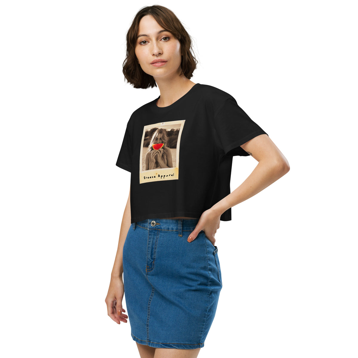 Woman wearing black crop top with graphic of woman holding piece of watermelon in front of her mouth.