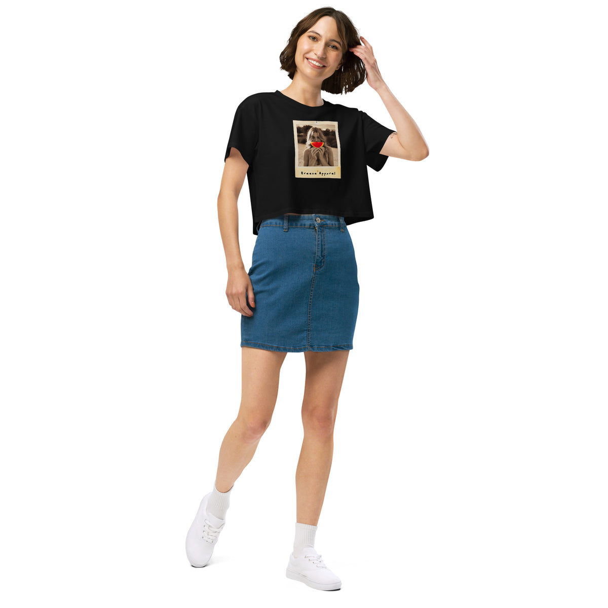 Woman wearing black crop top with graphic of woman holding piece of watermelon in front of her mouth.