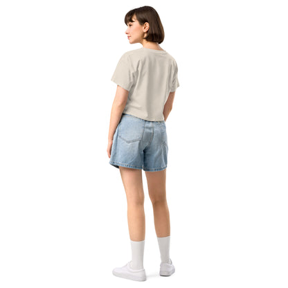 Rear view of woman wearing cream crop top.