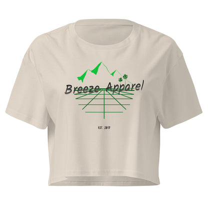 Cream crop top with graphic of palm trees and mountains.