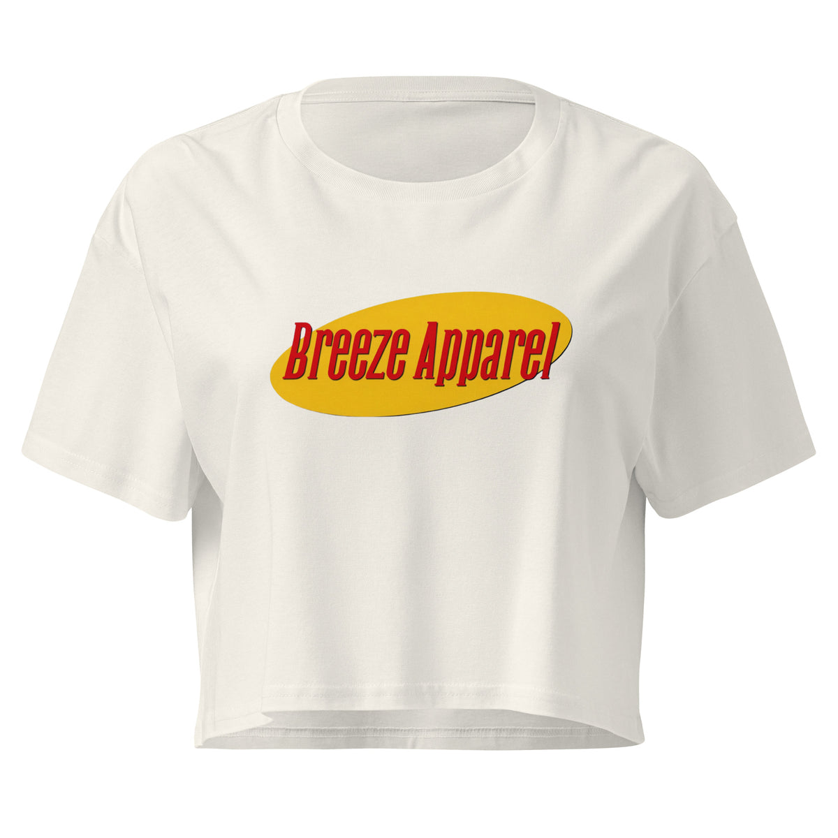 Cream crop top with graphic with red lettering set on a yellow oval. 