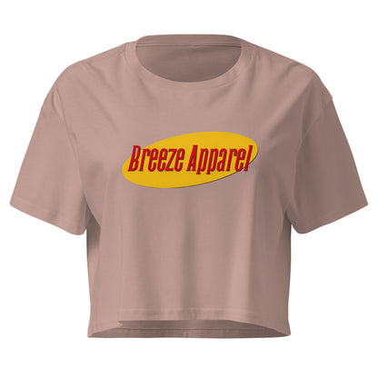 Mauve crop top with graphic with red lettering set on a yellow oval. 