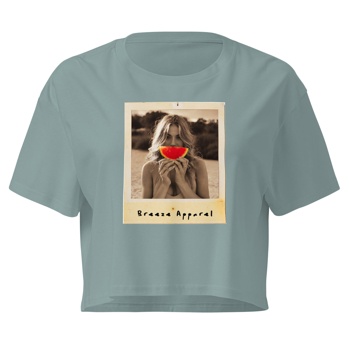 Green crop top with graphic of woman holding piece of watermelon in front of her mouth.