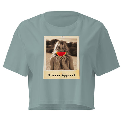 Green crop top with graphic of woman holding piece of watermelon in front of her mouth.