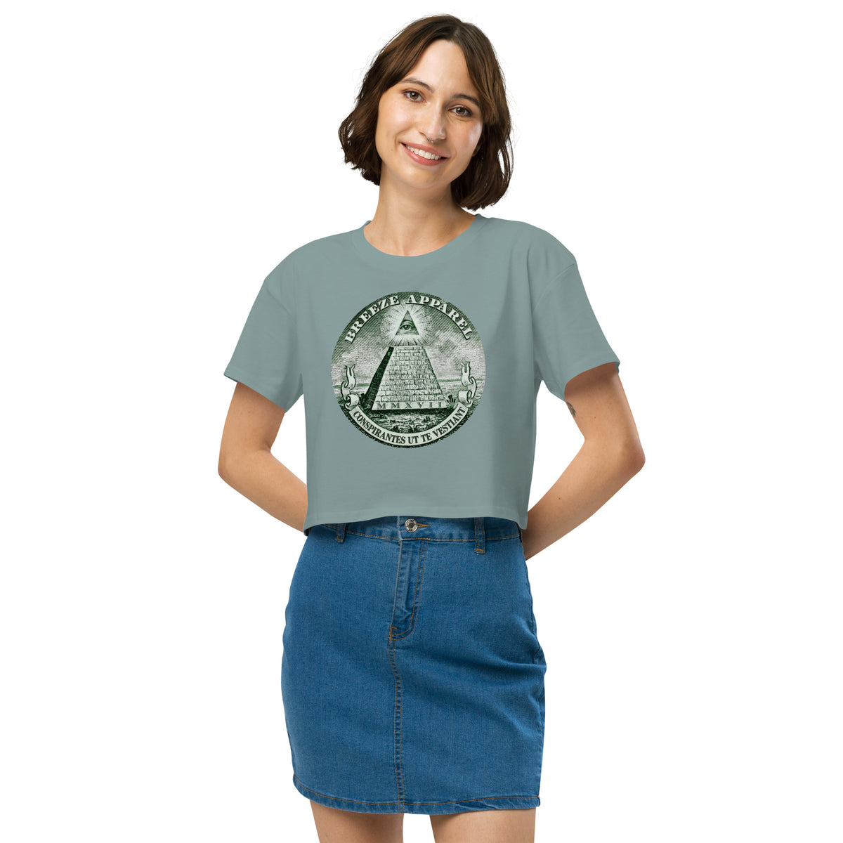 Woman wearing green crop top with graphic resembling pyramid from US one-dollar bill.