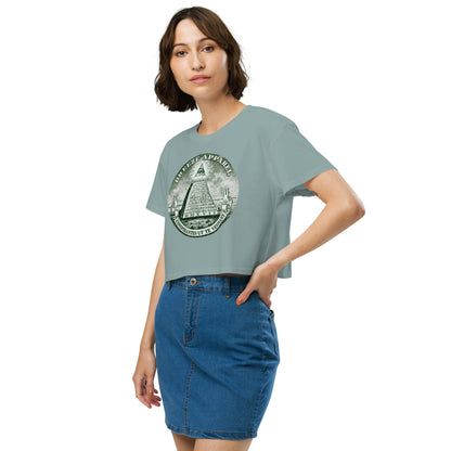 Woman wearing green crop top with graphic resembling pyramid from US one-dollar bill.