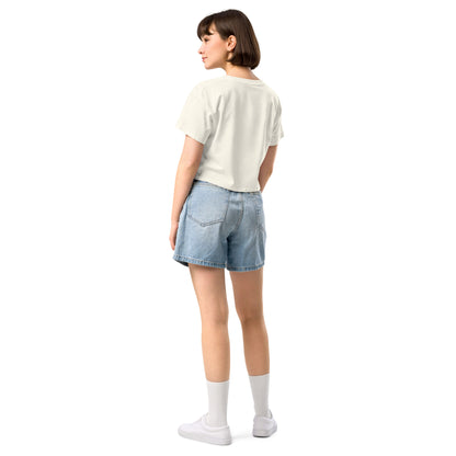 Rear view of woman wearing cream crop top.