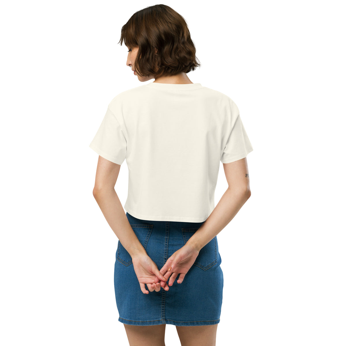 Rear view of woman wearing cream crop top.