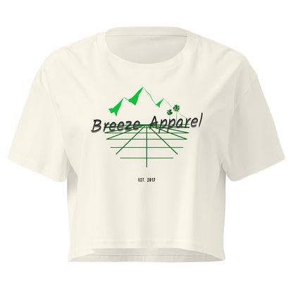 Cream crop top with graphic of palm trees and mountains.
