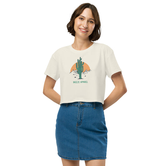Woman wearing cream crop top with cactus graphic.
