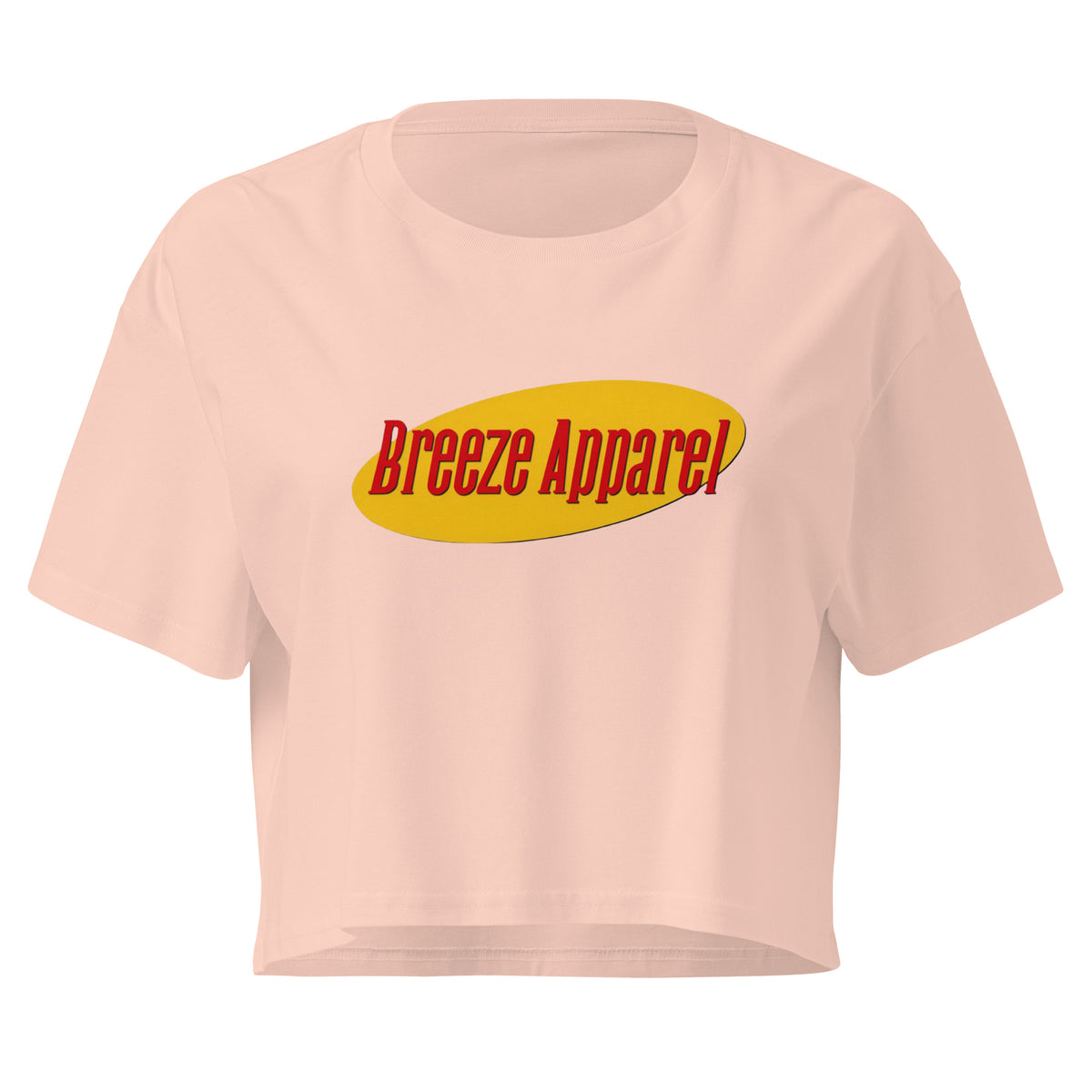 Pink crop top with graphic with red lettering set on a yellow oval. 