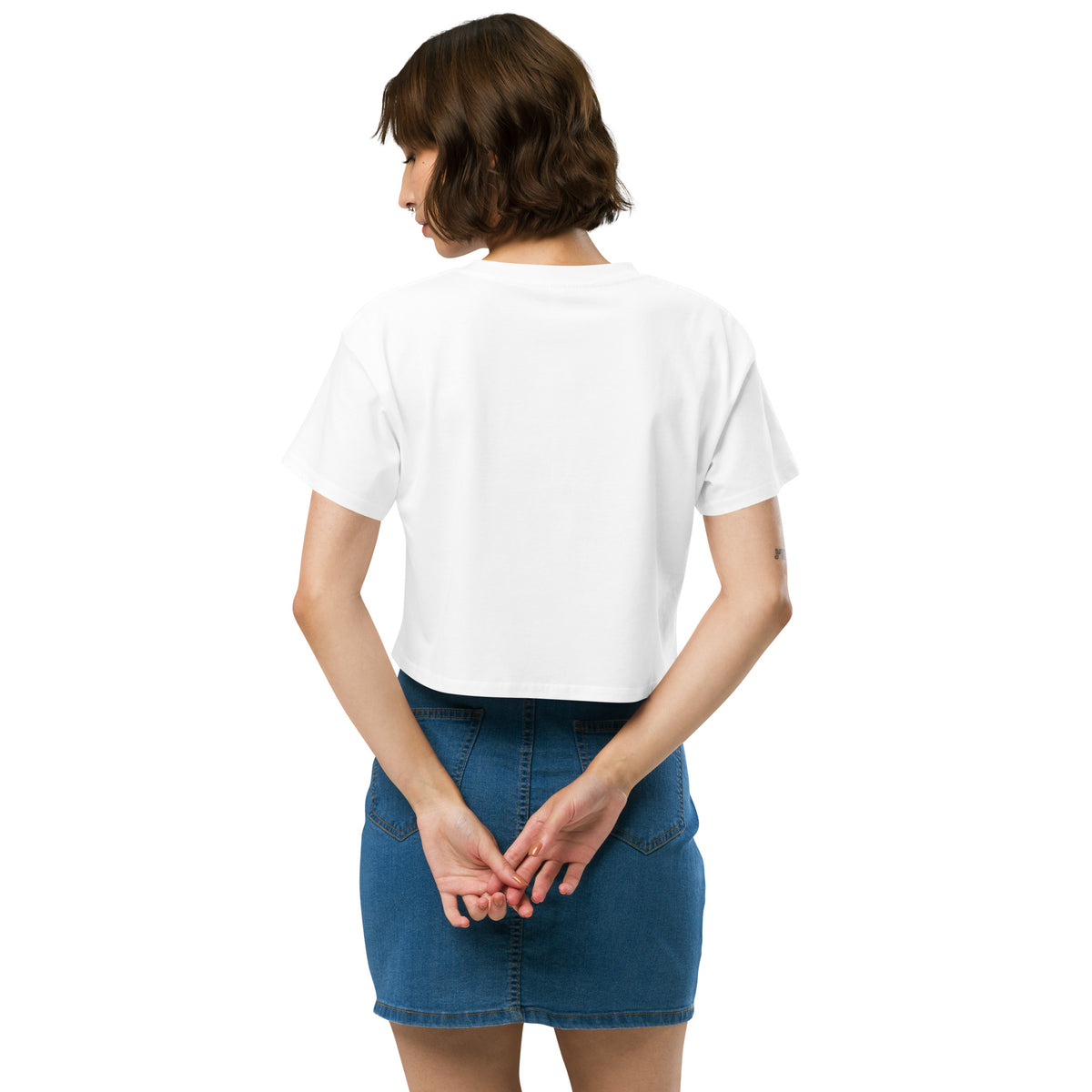 Rear view of woman wearing white crop top.