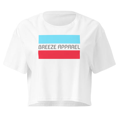 White crop top with graphic of gray lettering between blue and red horizontal bars.