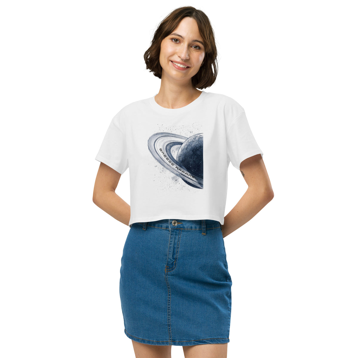 Woman wearing white crop top with graphic of blue planet.