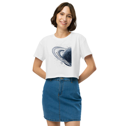 Woman wearing white crop top with graphic of blue planet.