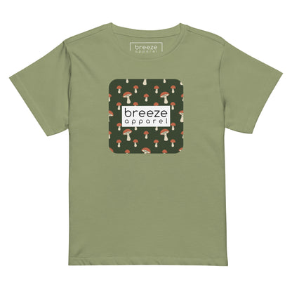 Light-green t-shirt with design of mushrooms set on green background and overlaid with a white rectangle with 'breeze apparel' in black inside.