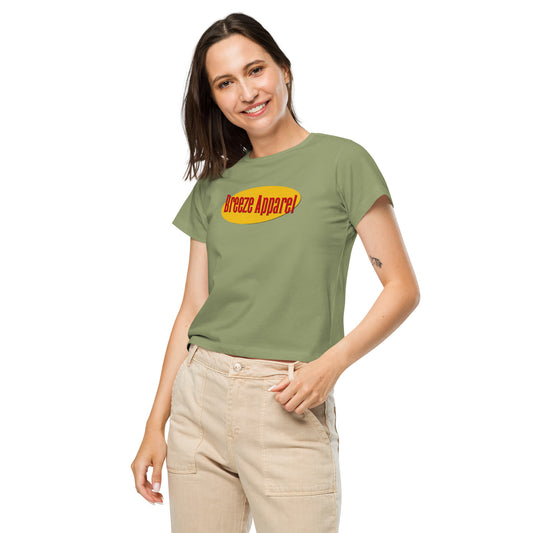 Woman wearing green t-shirt with red lettering over yellow oval.