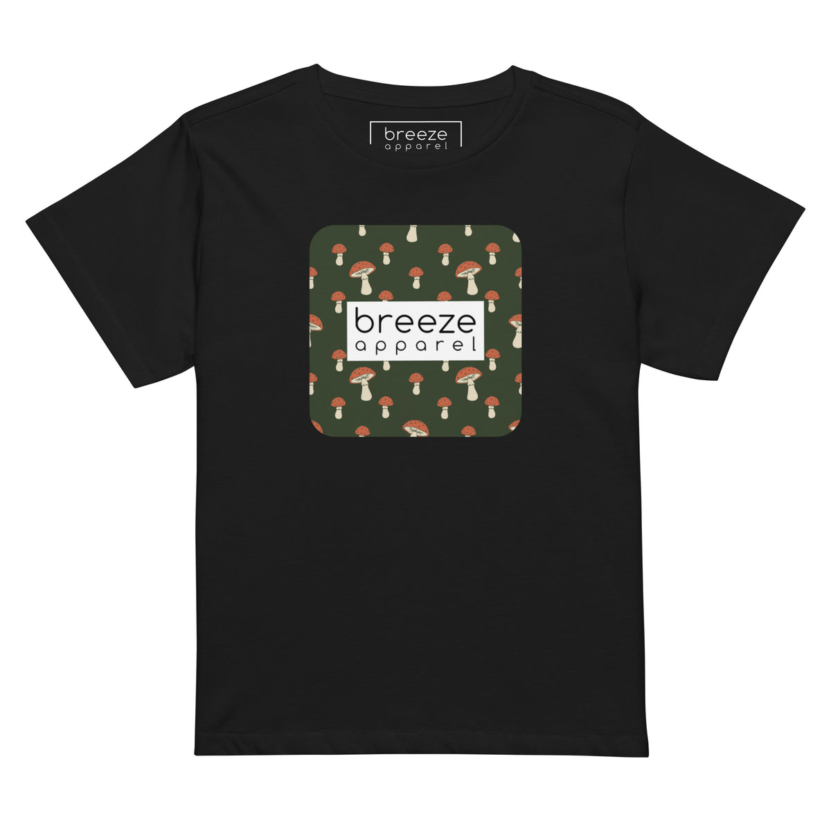 Black t-shirt with design of mushrooms set on green background and overlaid with a white rectangle with 'breeze apparel' in black inside.