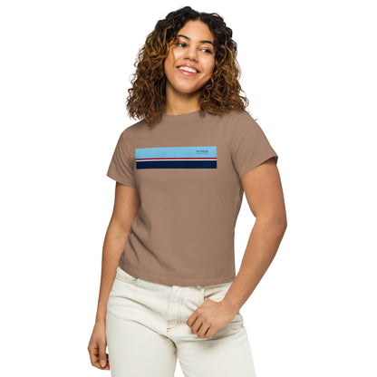 Woman wearing latte-brown t-shirt with horizontal blue, red, white, and navy stripe with small black 'breeze apparel' logo.
