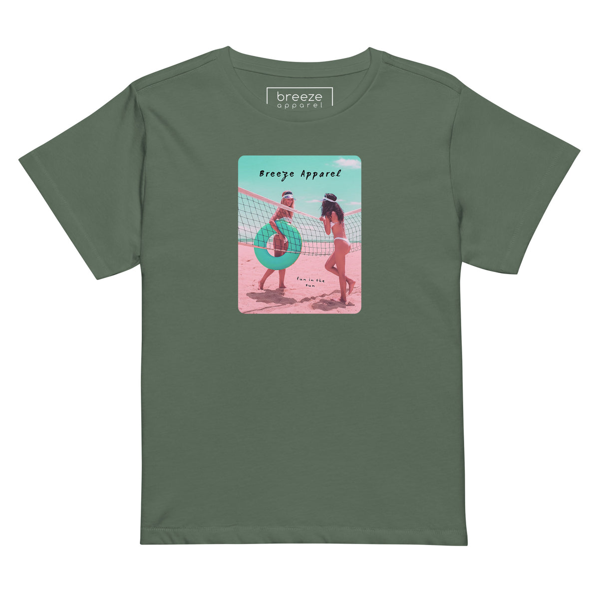 Pine-green t-shirt with an image of two women in bikinis on the beach, standing by a volleyball net, one holding a swim ring and smiling, the other leaning on the net, with inscription in black of 'breeze apparel' towards the top of the image, and 'fun in the sun' in black on the ground between the women. 