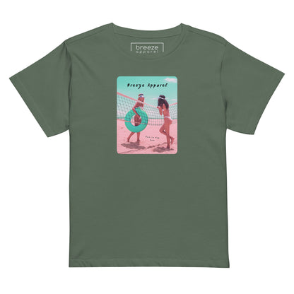 Pine-green t-shirt with an image of two women in bikinis on the beach, standing by a volleyball net, one holding a swim ring and smiling, the other leaning on the net, with inscription in black of 'breeze apparel' towards the top of the image, and 'fun in the sun' in black on the ground between the women. 