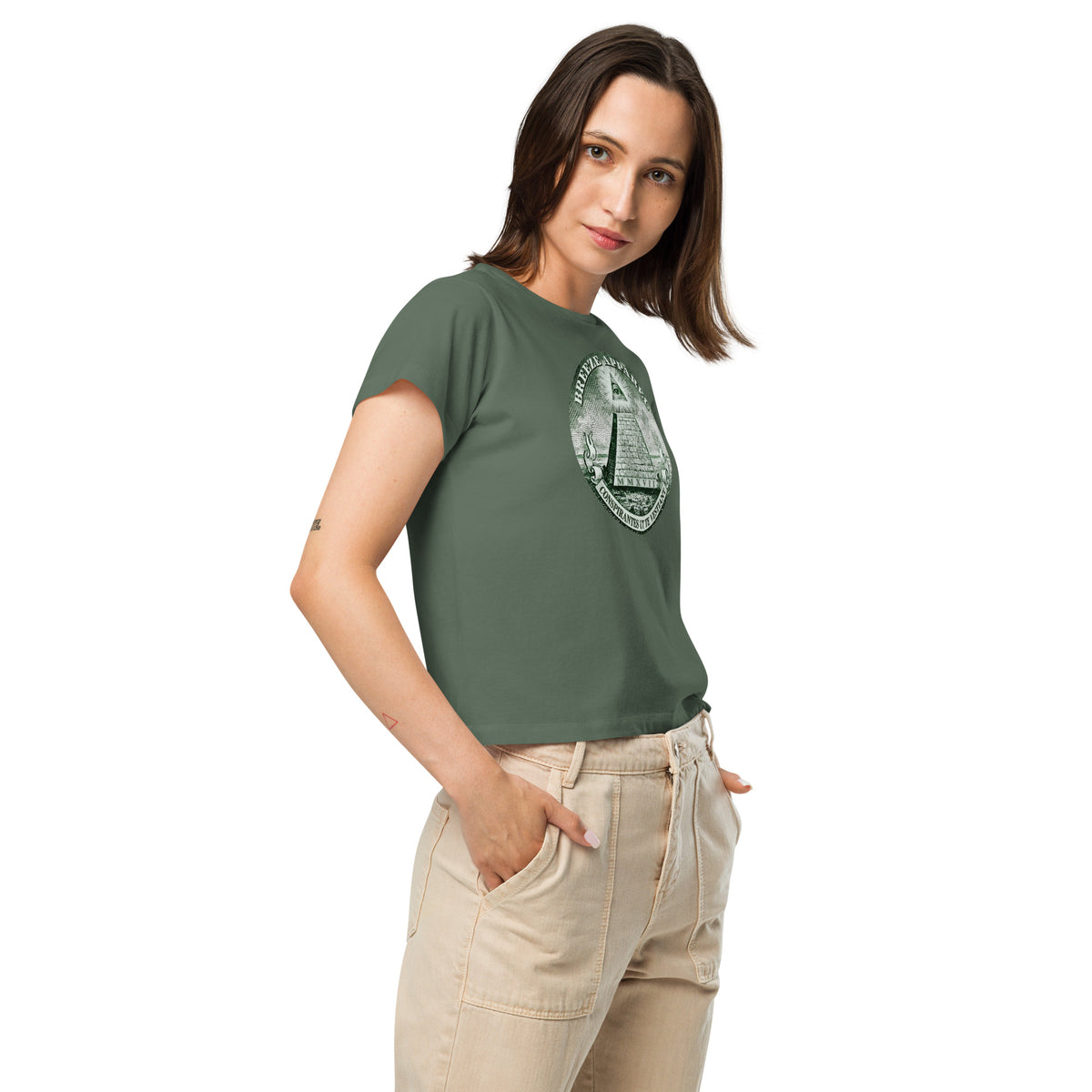Woman wearing green t-shirt with graphic resembling pyramid on US one-dollar bill.