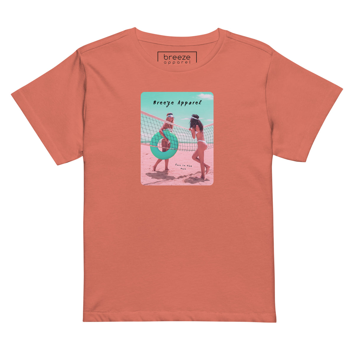 Red-sorbet t-shirt with an image of two women in bikinis on the beach, standing by a volleyball net, one holding a swim ring and smiling, the other leaning on the net, with inscription in black of 'breeze apparel' towards the top of the image, and 'fun in the sun' in black on the ground between the women. 