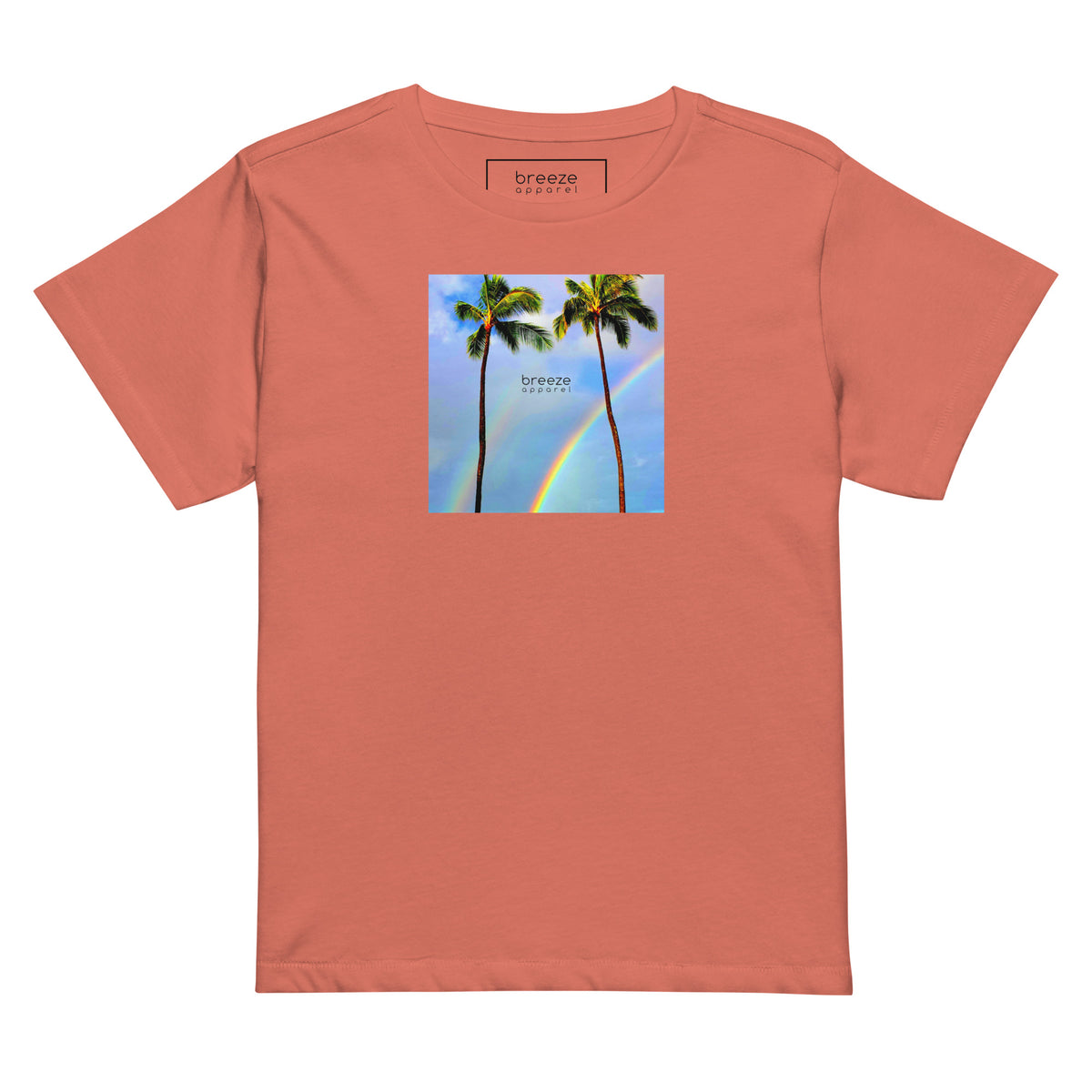 Red-sorbet t-shirt with a graphic of palm trees, rainbow, and a clear blue sky in the background. A small, black 'breeze apparel' logo is between the trees.