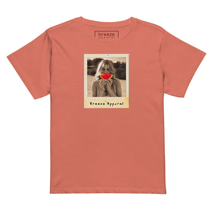 Orange t-shirt with graphic of woman holding a watermelon slice in front of her mouth.