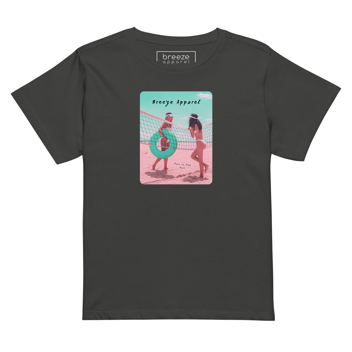 Vintage-black t-shirt with an image of two women in bikinis on the beach, standing by a volleyball net, one holding a swim ring and smiling, the other leaning on the net, with inscription in black of 'breeze apparel' towards the top of the image, and 'fun in the sun' in black on the ground between the women. 