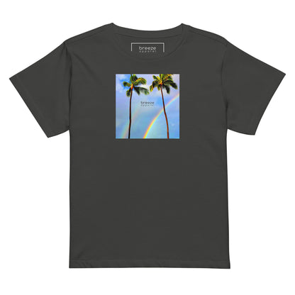 Vintage-black t-shirt with a graphic of palm trees, rainbow, and a clear blue sky in the background. A small, black 'breeze apparel' logo is between the trees.