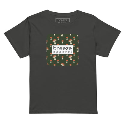 Dark-gray t-shirt with design of mushrooms set on green background and overlaid with a white rectangle with 'breeze apparel' in black inside.