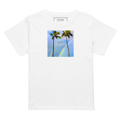 White t-shirt with a graphic of palm trees, rainbow, and a clear blue sky in the background. A small, black 'breeze apparel' logo is between the trees.