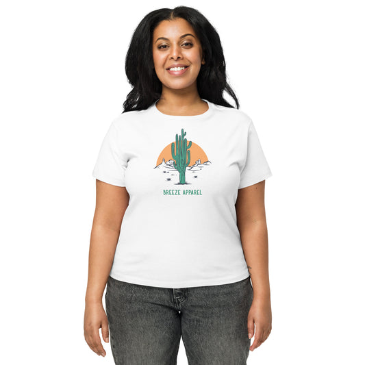 Woman wearing white t-shirt with a graphic of a cactus and sunset, with 'Breeze Apparel' written in green below.