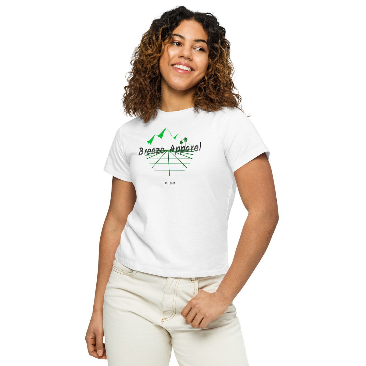 Woman wearing white t-shirt with 'Breeze Apparel' logo set on a graphic of a grid, palm trees, and mountains.